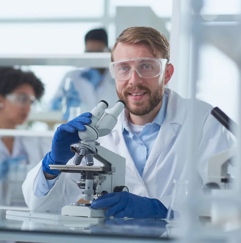 A scientist looking into a microscope