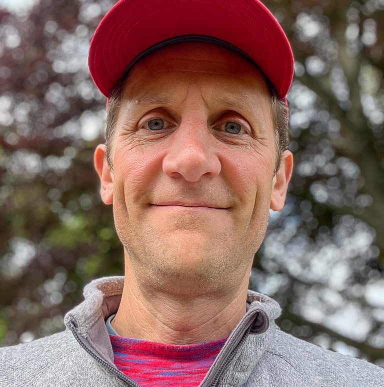 Headshot of Marcus wearing a red hat