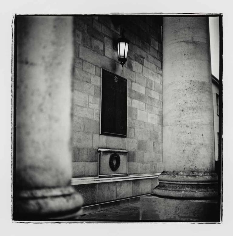 A plaque on the wall in Cambridge University building, 2024.