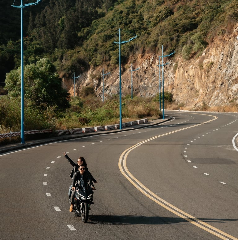 a man riding a motorcycle down a road