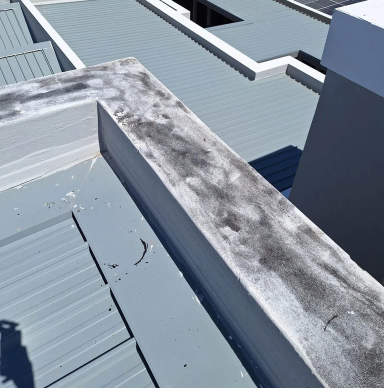 Roof flashing lifted near parapet wall