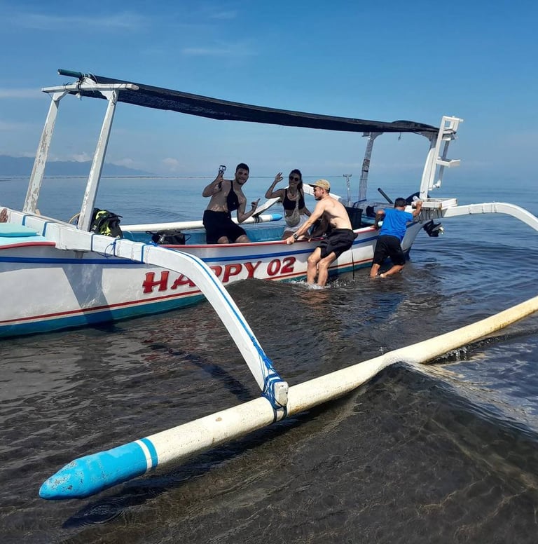 a man is getting ready to go out on a boat at lovina reef