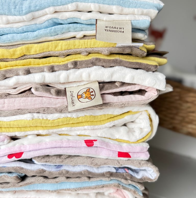 įvairių spalvų vaikiškų pledukų rinkinys