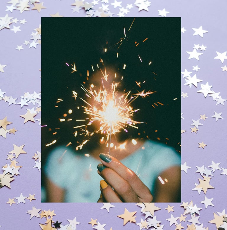 person holding a bright sparkling light surrounded by stars