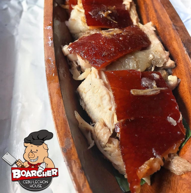 lechon slices on a wood plate