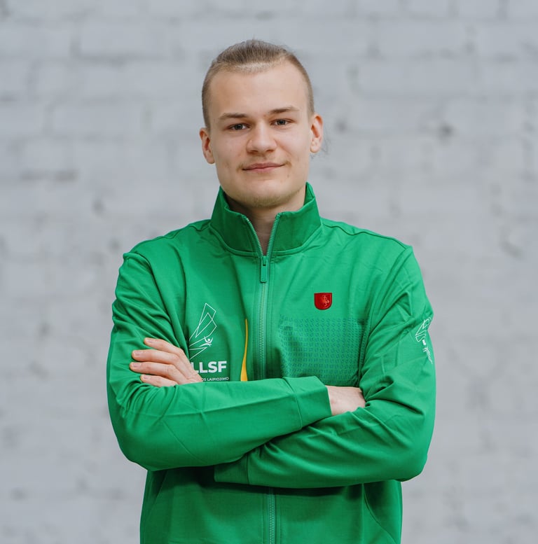 a man in a green jacket and crossed arms