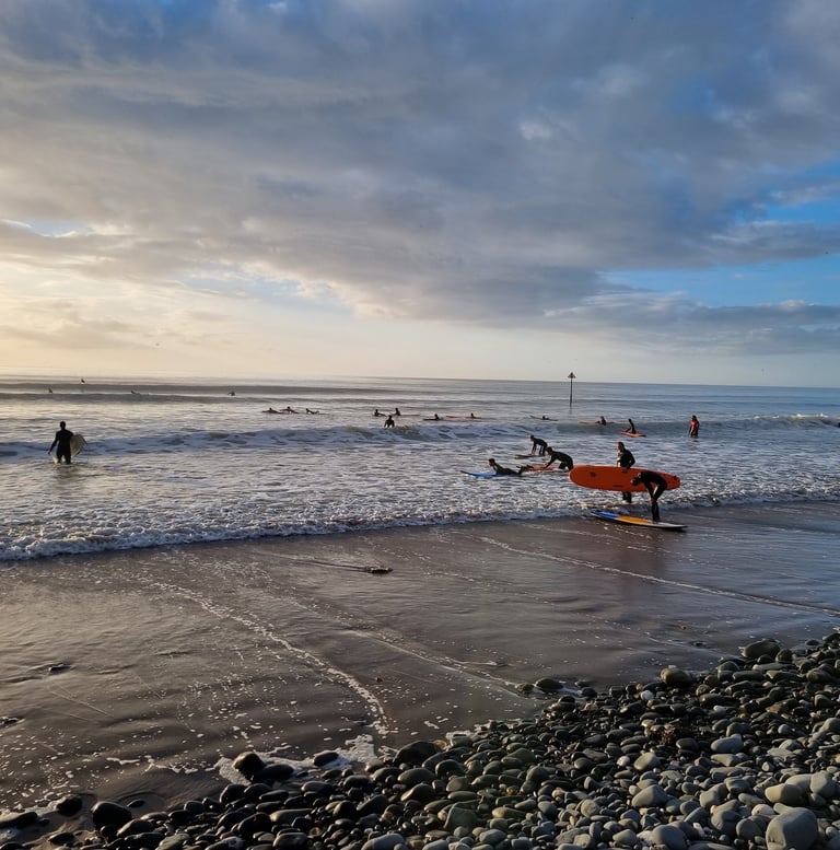 A busy surf lesson at Ynyslas in late evening autumn sunshine