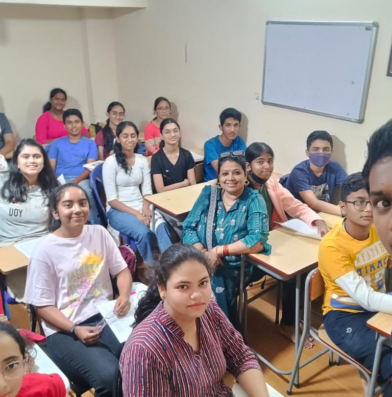 a group of people sitting at desks in a classroom