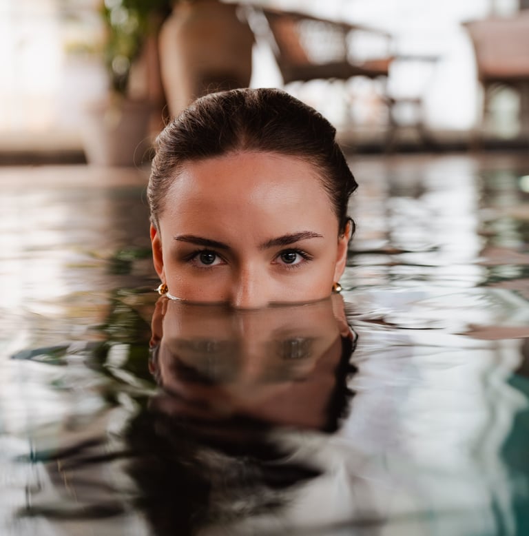 Women in pool with reflections from the water