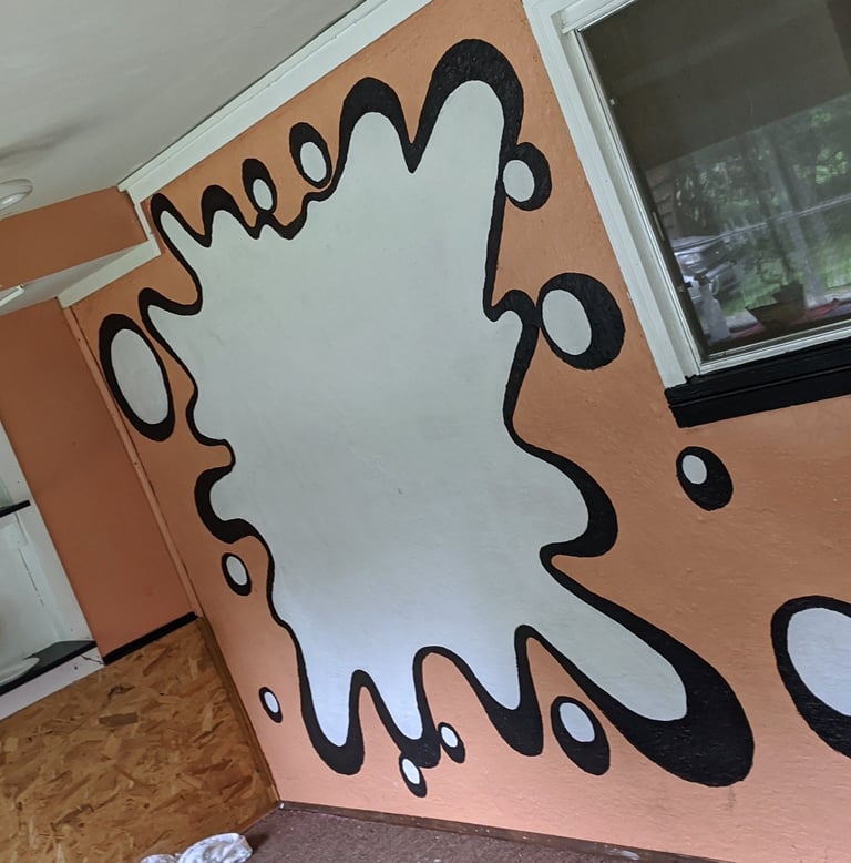 a room with a wall mural of a large splat
