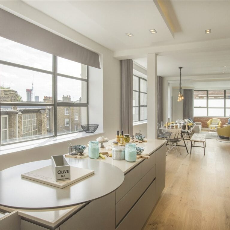 a kitchen with a large window and a table with a phone