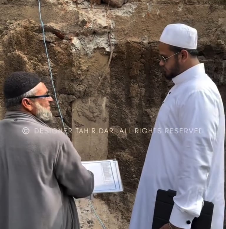 Engineer and architect in Hyderabad discussing construction plans with workers on-site, showcasing t