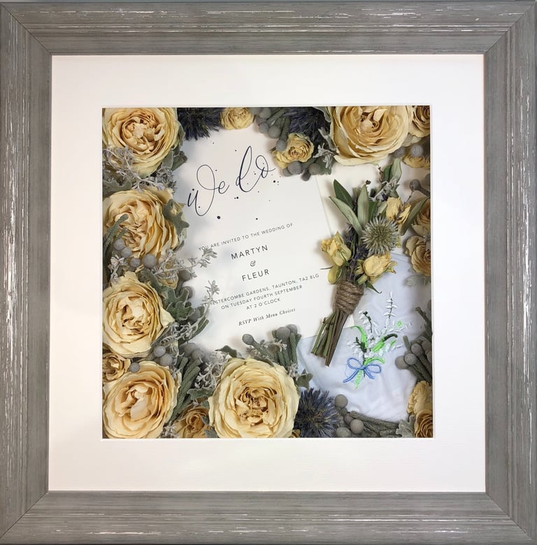 a memory box with keepsakes and a preserved wedding bouquet in a frame