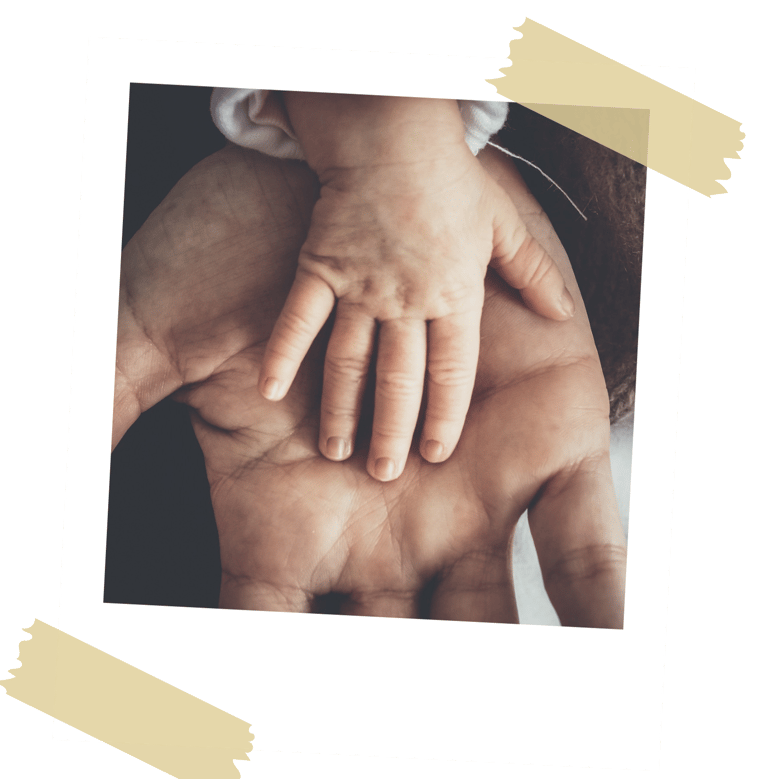 Father holding a baby's hand