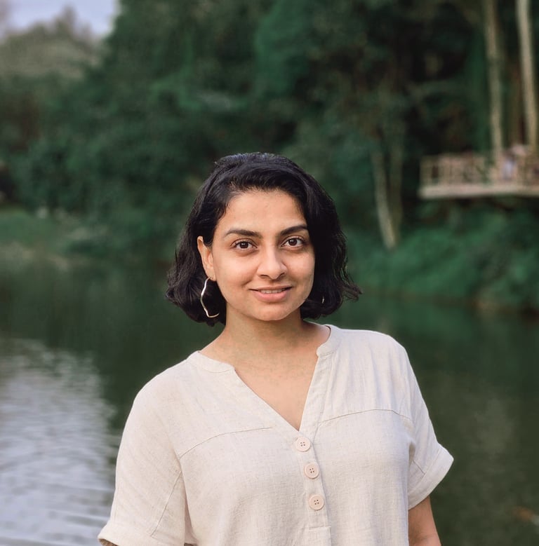 Mita Menezes, relationship and trauma psychologist at Turtle Balance, smiling in a natural outdoors