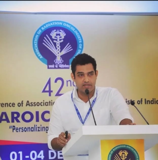 Dr. Abhishek Krishna, oncologist in Mangalore speaking at AROI conference.
