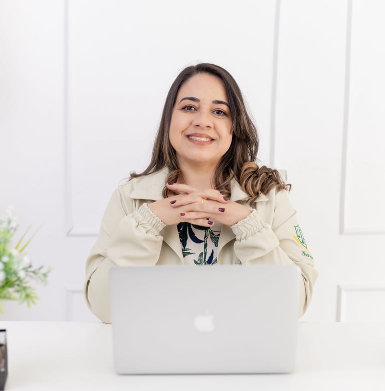 a woman sitting at a desk with a laptop