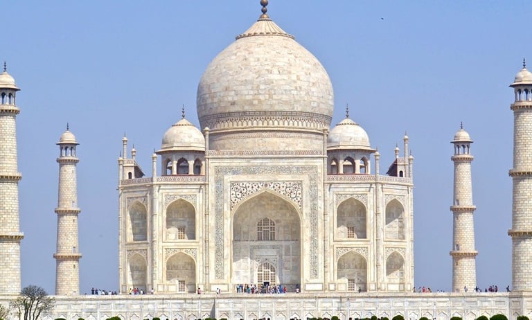 Taj Mahal a large white building with a large dome shaped building