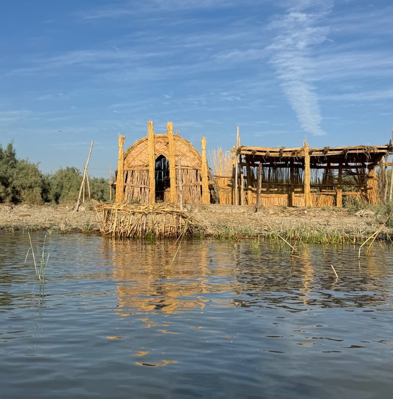 A shot of a reed house in Chibayish marshes reflected in the marsh water.