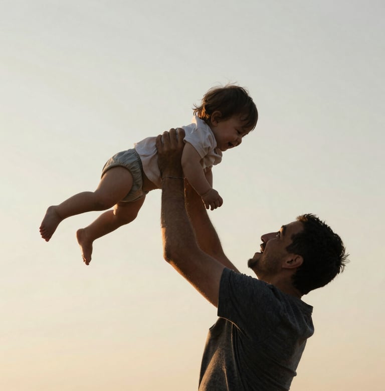 A father lifting a toddler high into the air against a clear, soft off-white sand sky. The composition is a low-angle silhouette with warm golden light outlining their shapes. Cinematic and evocative.