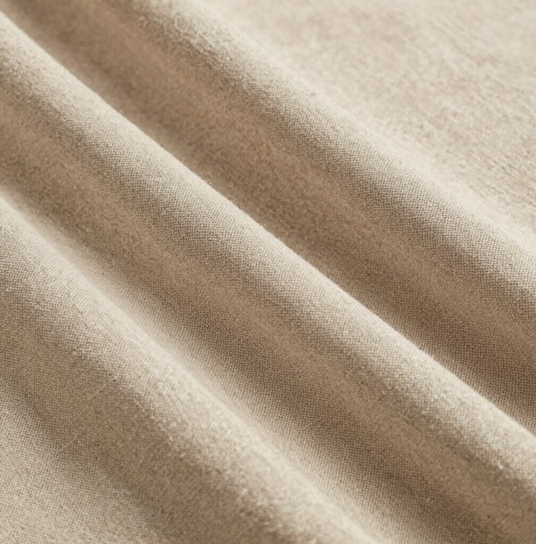 Close-up photography of a thick linen fabric texture in a soft sand color, professional studio lighting, minimalist and sophisticated feel, European / Spanish design.