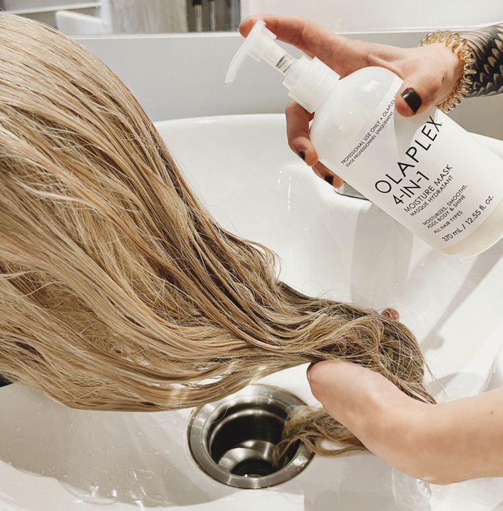 Hair model applying Olaplex during color treatment.