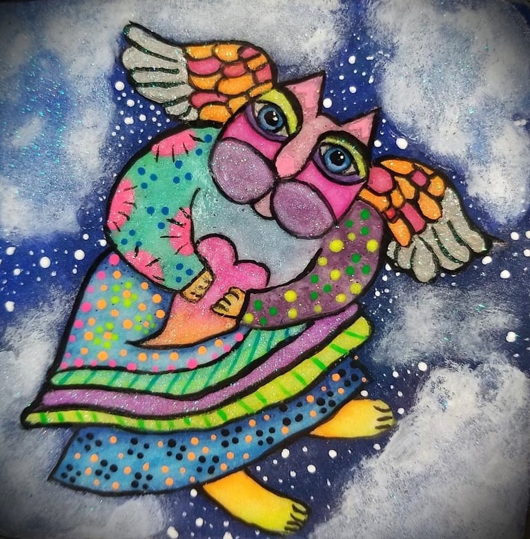 A rock painting of a fairy kitty in bright colors using Laurel Burches art style..