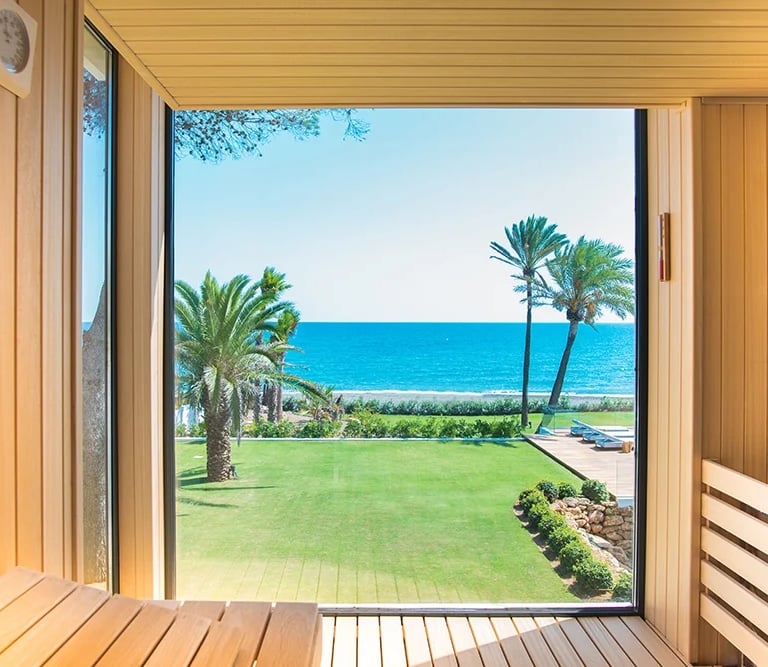 Sauna interior with garden and ocean views
