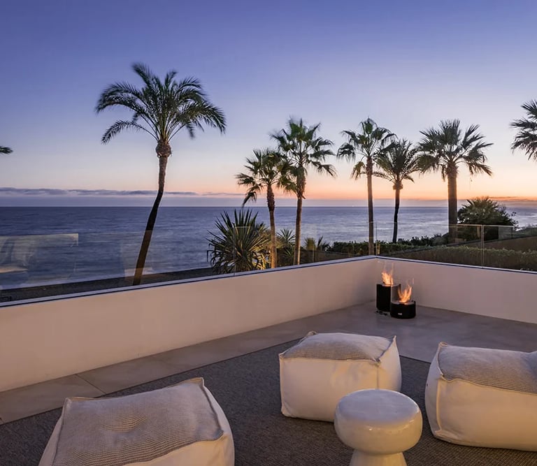 Rooftop terrace lounge with fire features and sunset views