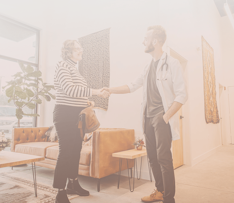 Patient shaking hands with doctor
