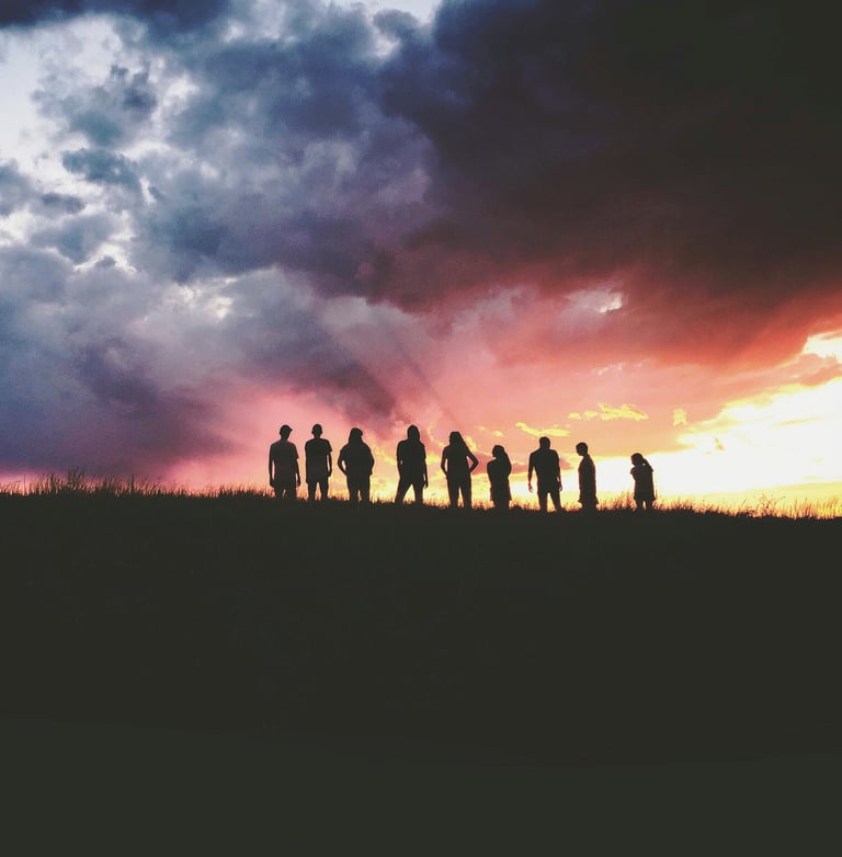 a group of people standing on a hill top
