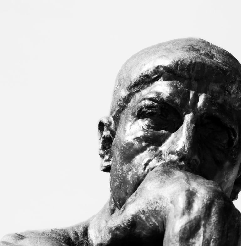 Rodin's The Thinker bronze statue head and hand.