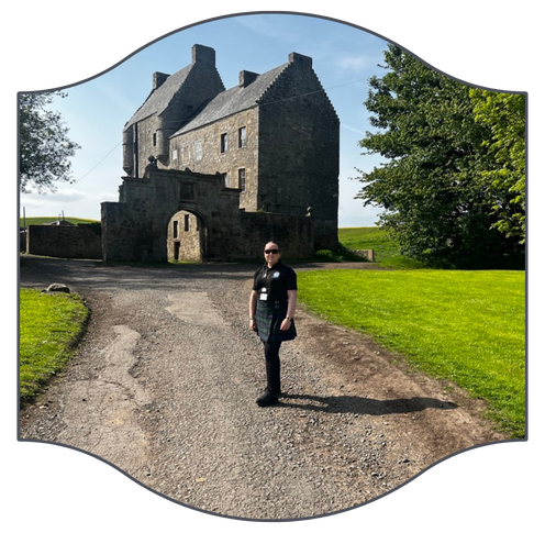 the scottish tour guide standing in front of Midhope Castle.