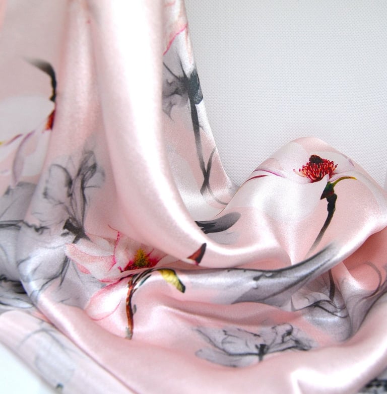 a pink scarf with a bird on it