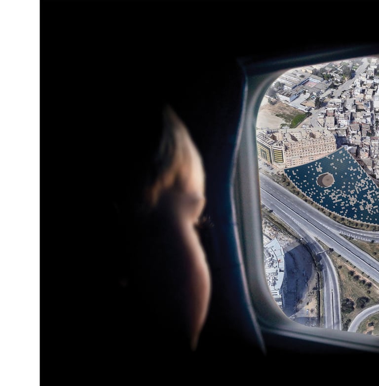 A photo of a child looking through an airplane window at a giant solar roof