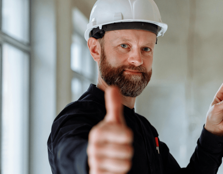 A Service Buisness Tech giving the thumbs up on a booked job site  Photo by Thirdman 