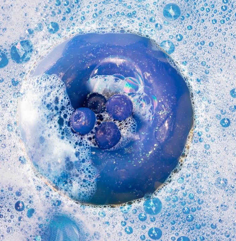 a blue doughnut in a bathtub with bubbles