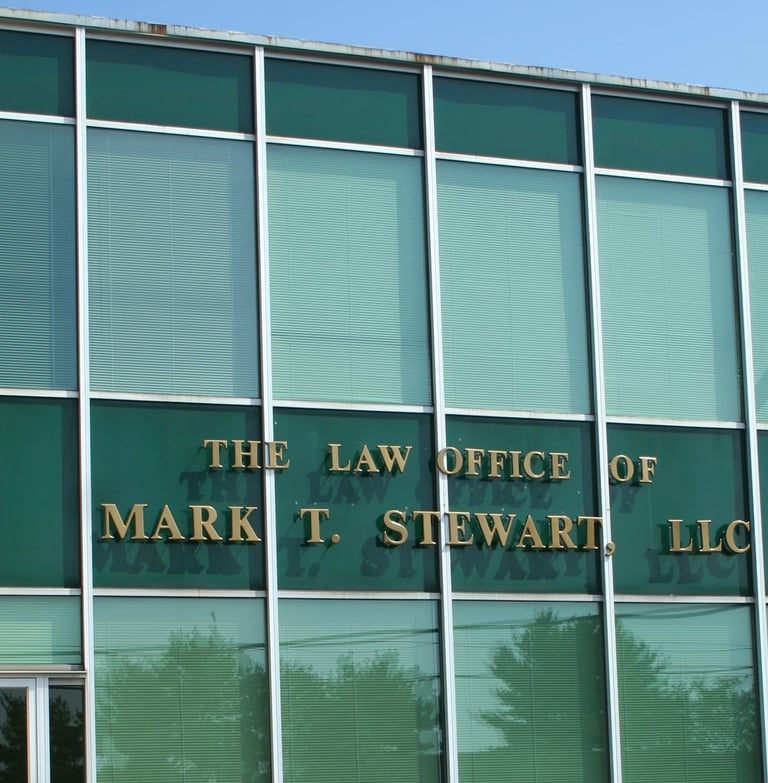 a building with a sign that says the law office of Mark T. Stewart