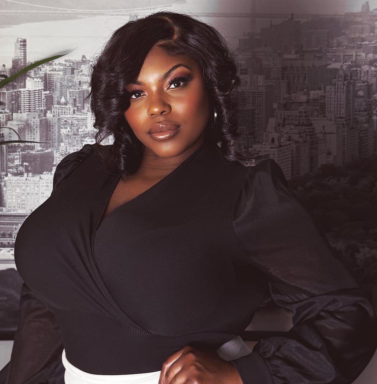 a woman in a black top and white pants