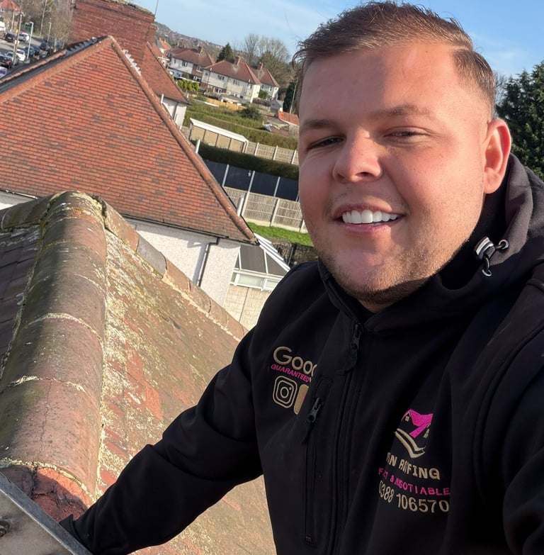 Professional roofing contractor smiling while inspecting residential roof ridge tiles during a maintenance service.