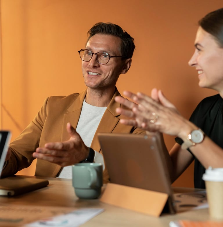 Professional business colleagues having a collaborative meeting with tablets in a modern office.