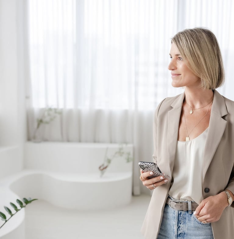 Psychotherapist Yvonne has a phone and looks to the side in a soft light