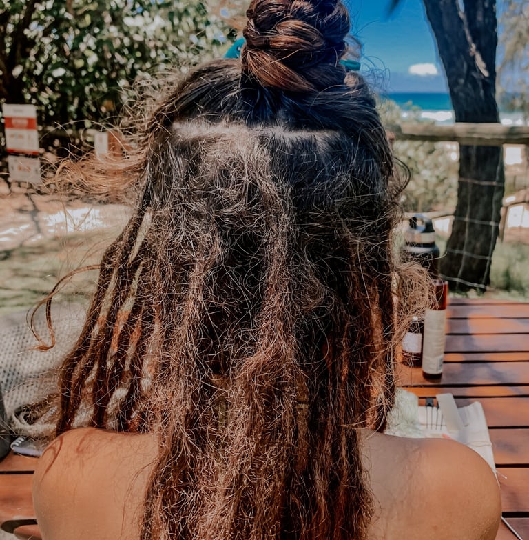 a woman with dreadlocks in her hair