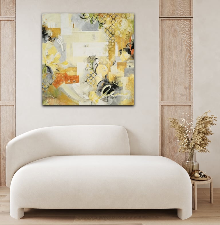 Modern yellow and grey abstract canvas art above a white curved sofa in a minimalist living room.