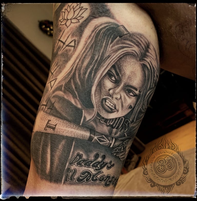 Realistic tattoo of Harley Quinn on the bicep