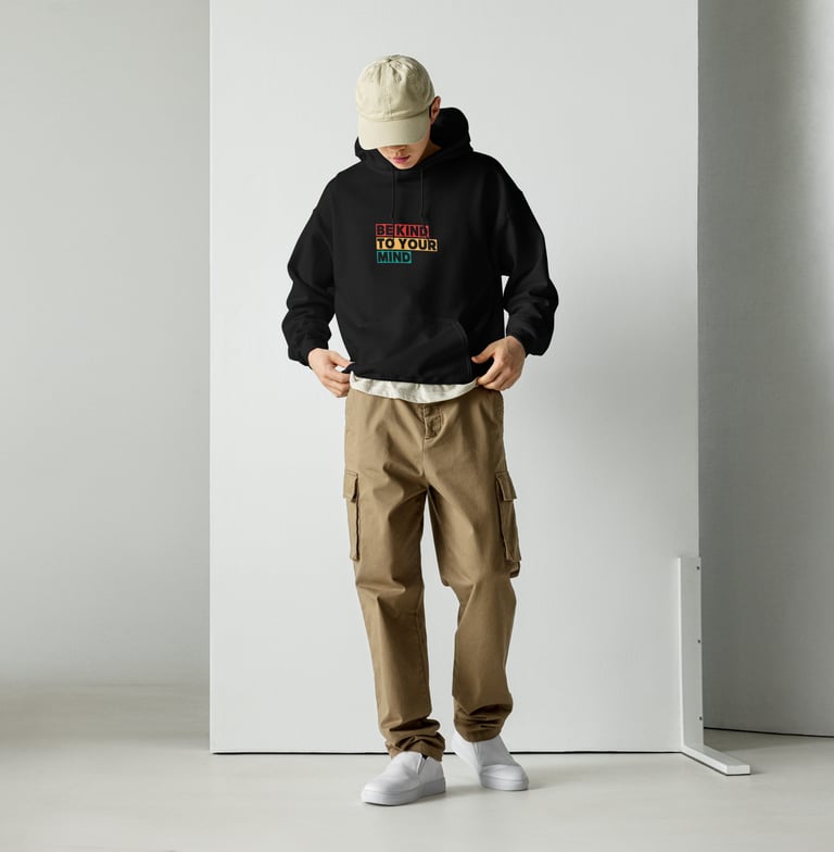 a man in a black hoodie and a hat