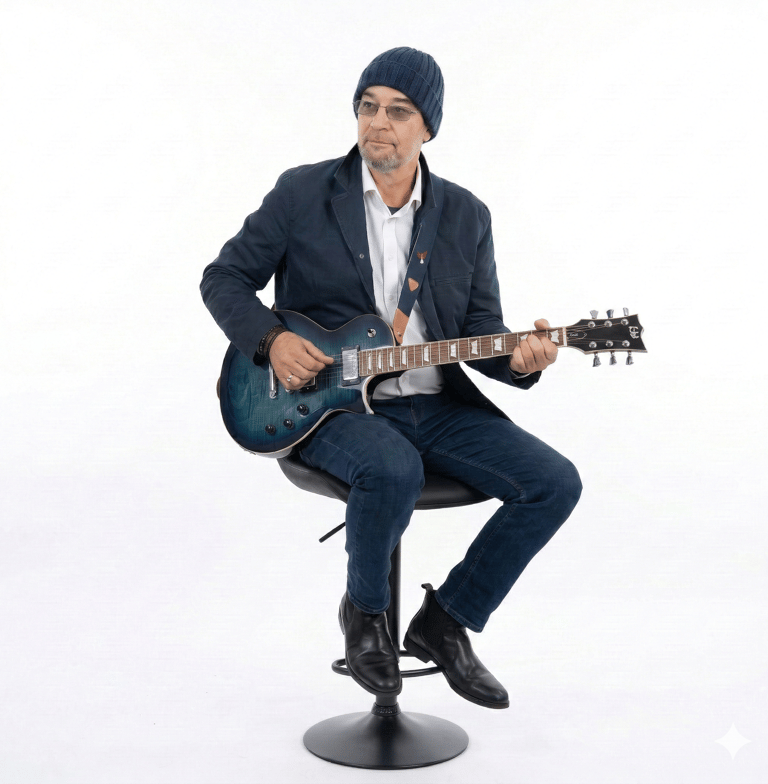 photo of mandrak sitting on a bar stool with a guitar
