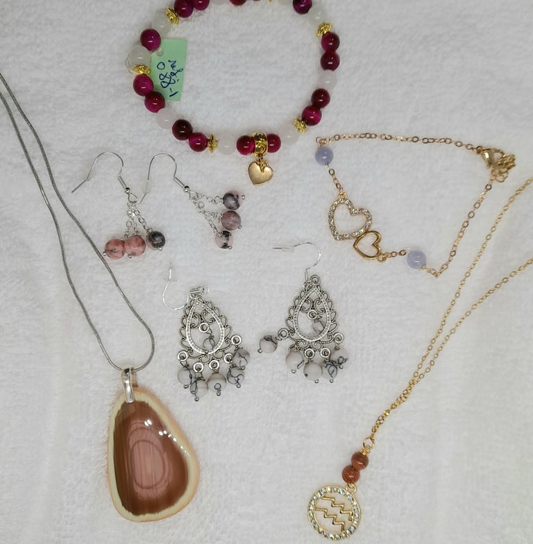 a variety of jewelry and jewelry on a white surface
