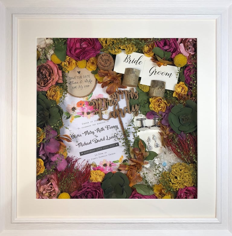 memory box full of preserved wedding flowers, place names, save the date, cork and cufflinks