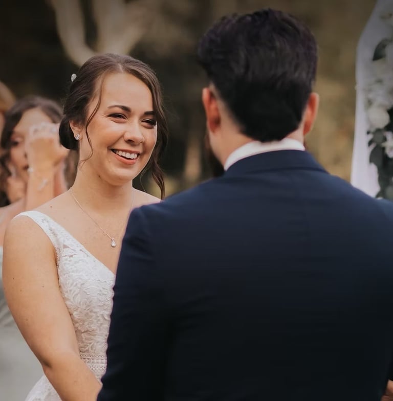 a bride and groom smiling at each other